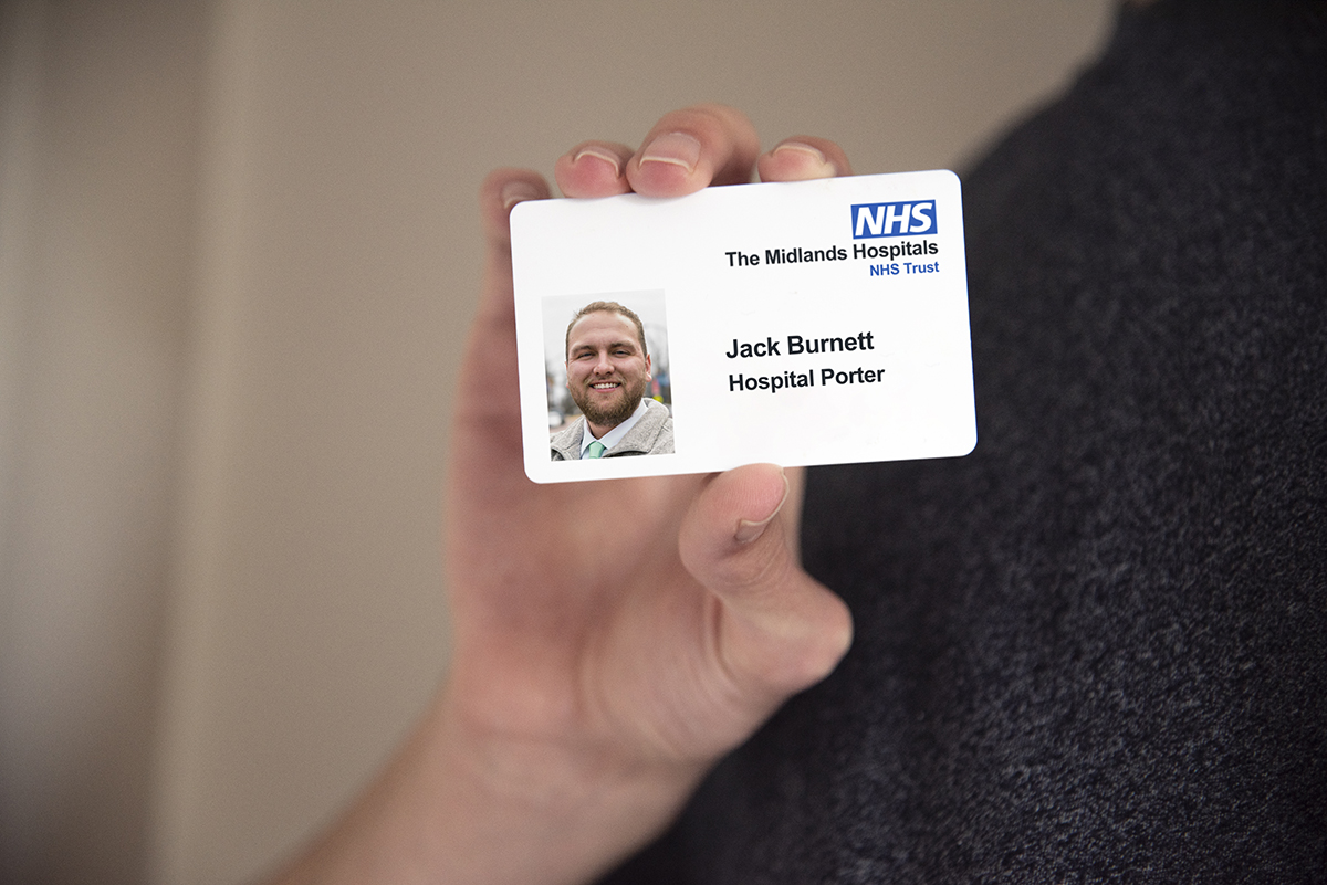 NHS ID card sample in hand